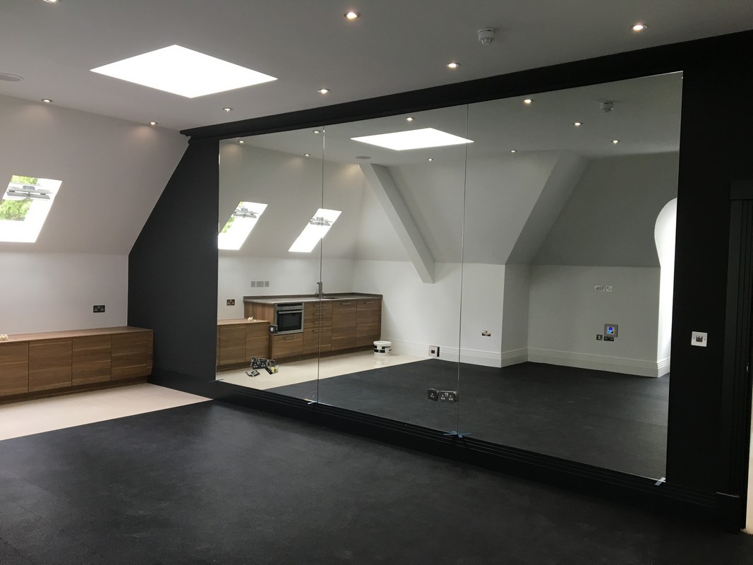 Frameless glass wall dividing loft conversion in Shoreditch