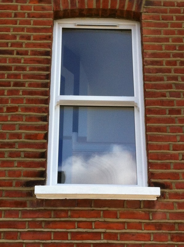 uPVC sash window on Victorian red brick house in Shoreditch